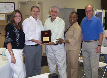 Ranger South Division President Hazen Hinds, second from left, and Vecellio Group V.P. of Safety John West, right, receive a commemorative safety plaque from Dana Miller, Edward Aber and Donna Coleman-Jones, all with Travelers. (Photo by Mike Scarborough) 