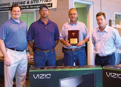 Steve Beals, right, presents a plaque honoring Sharpe Bros. safety record to Vecellio Group V.P. Michael Vecellio, left, Sharpe Bros. Field Safety Manager John Riley, Jr., and Sharpe V.P. Ivan Clayton.  (Photo by Gloria Fields)
